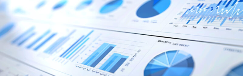 Graphs and charts in varying shades of blue, including bar graphs, line charts, and pie charts, representing data analysis or business reports.